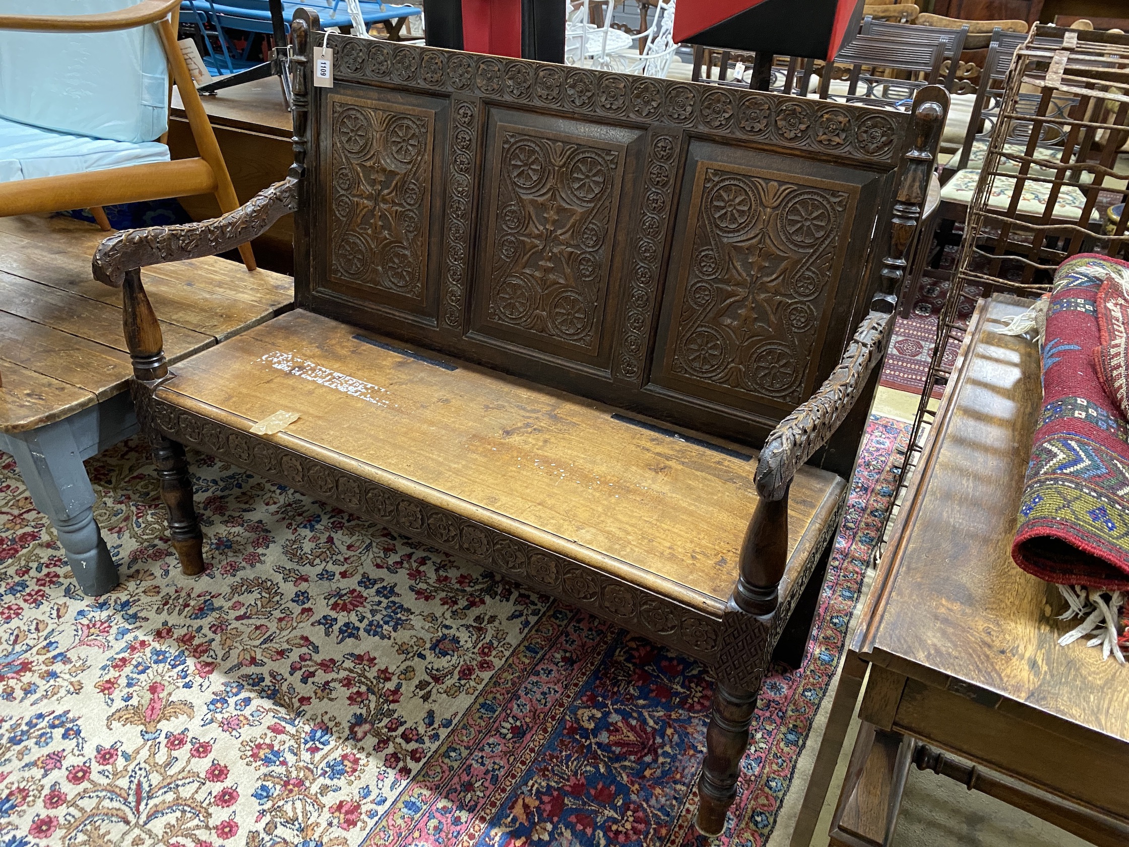 A Victorian carved oak settle, length 122cm, depth 50cm, height 104cm